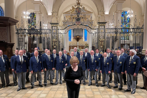 choir with musical director preparing to perform
